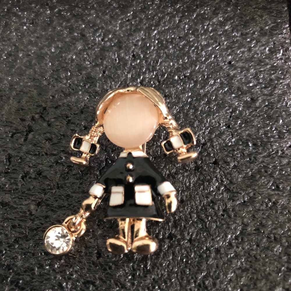 Girl in enamel black coat ponytails brooch